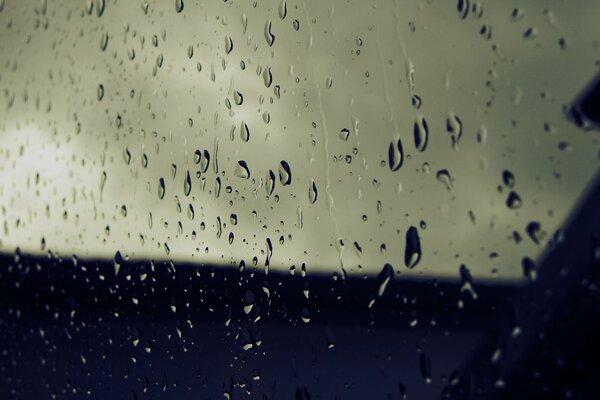 Autumn rain drops on the glass