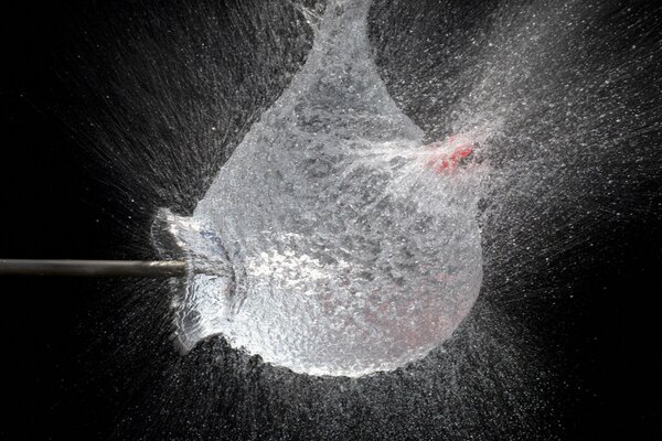 Explosion of a vessel with water in motion