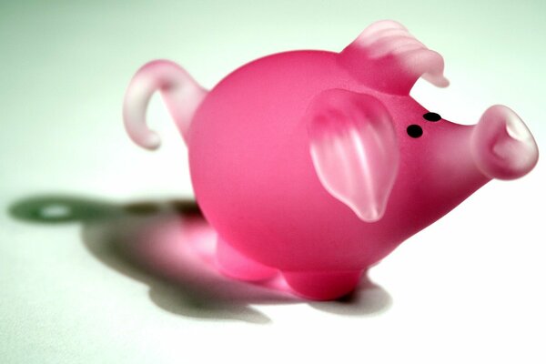 Glass figurine of a pink pig on a white background