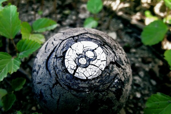 A billiard ball in the grass with the number eight on it