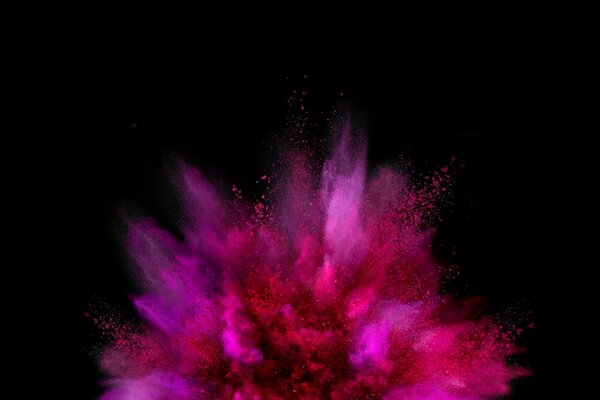 An explosion of pink paint on a black background