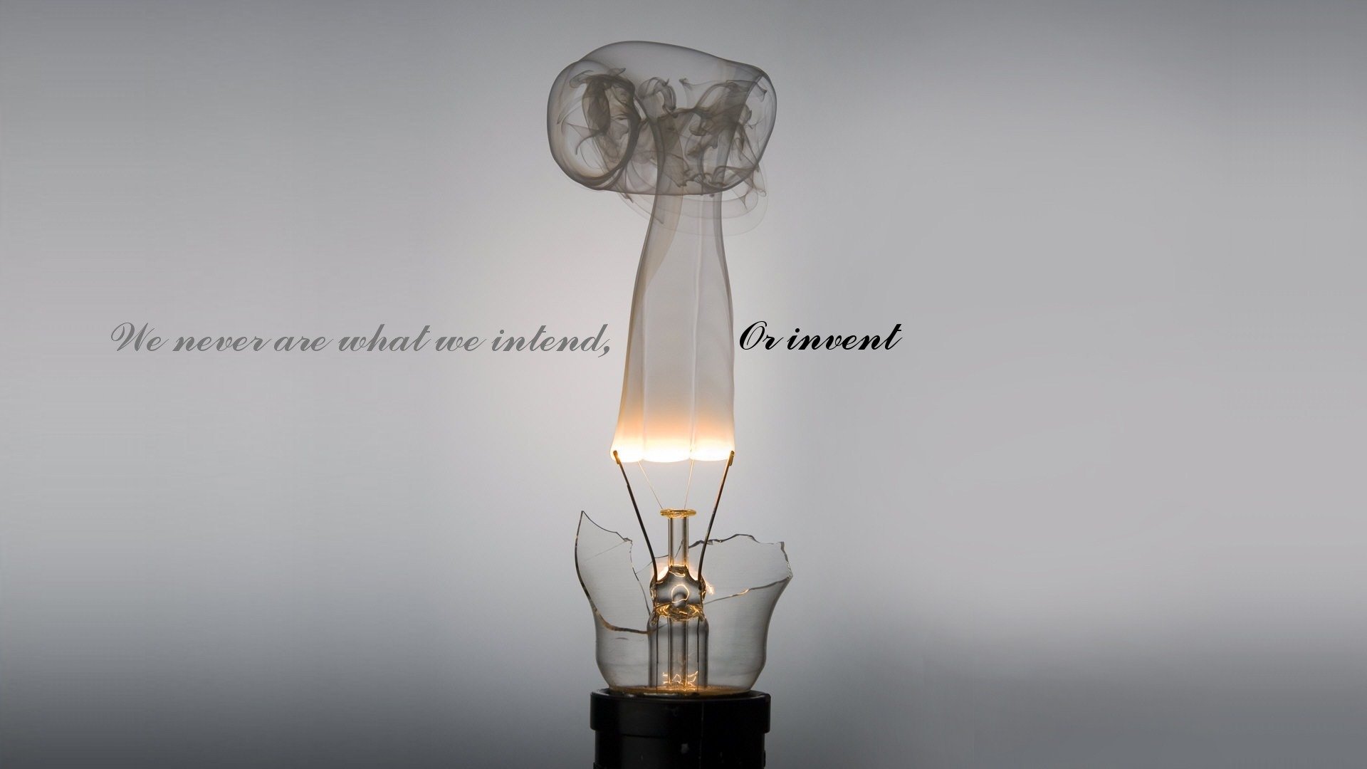 minimalism grey background light inscription we never are what we intend or invent