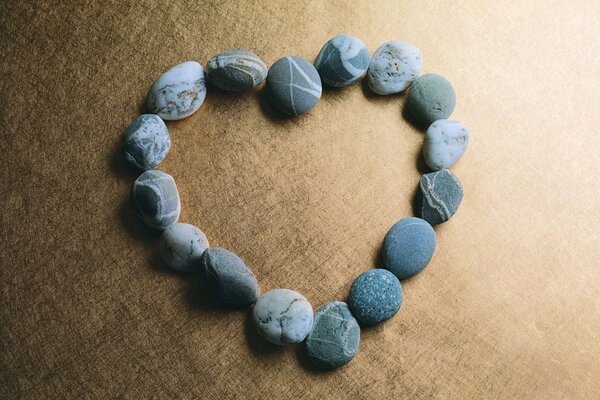 A heart made of stones on a brown background