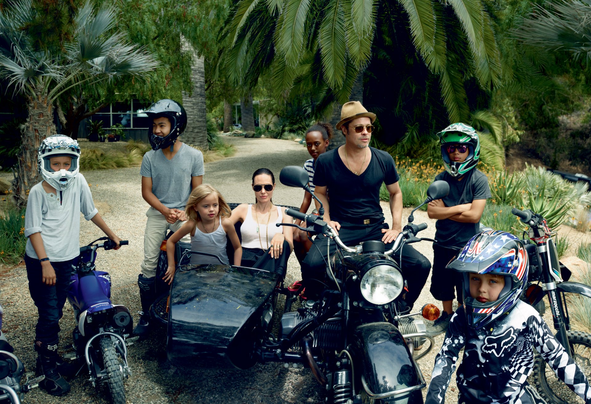 angelina jolie brad pitt actors celebrity children family bike helmet sunglasses hat palm walk photo annie leibovitz vogue