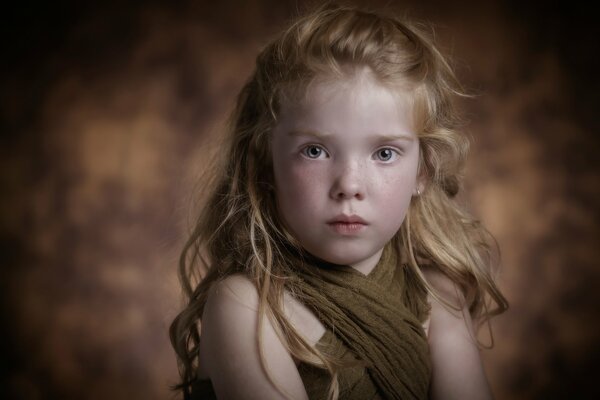 Portrait of a curly-haired red-haired girl