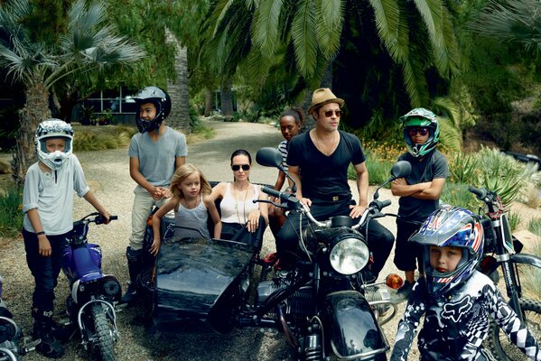 Angelina Jolie and Brad Pitt with their family on a motorcycle