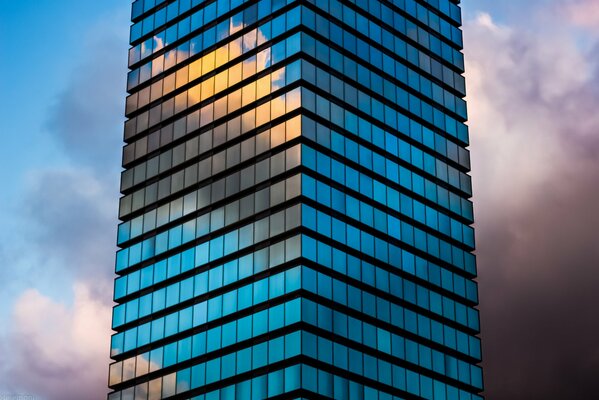 Glass high-rise building with cloud reflection