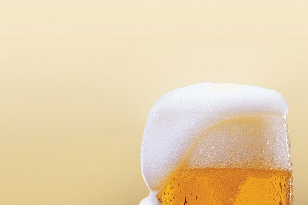 A glass of beer with volumetric foam