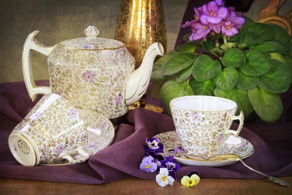 Tea set and cups and teapot in a flower