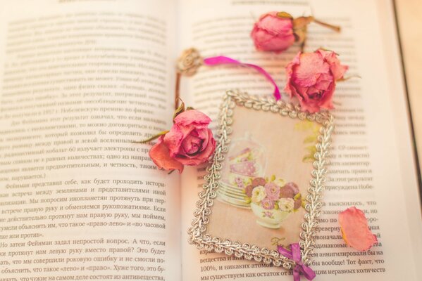 The book on which the bookmark with roses is located