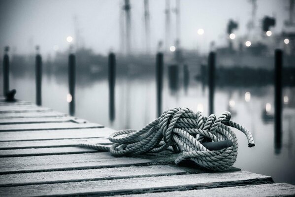 Rope on a wooden pier in the port