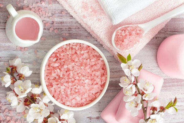 Sea salt and a sprig of flowers us a towel in pink style