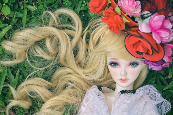Toy doll blonde in a flower hat