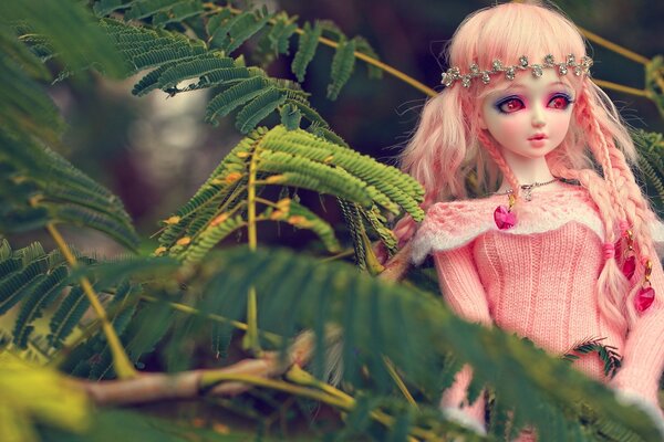 Anime doll among green leaves
