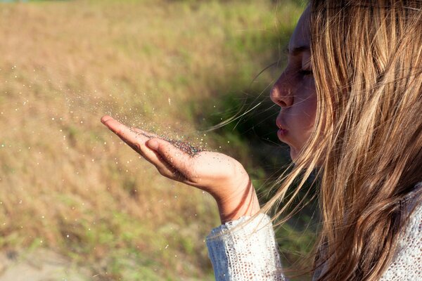 A girl s breath on the palm of a grain of sand