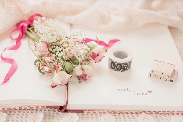 Vintage painting bouquet of roses lies on a notebook