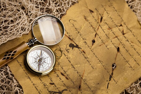 Picture of a letter with a magnifying glass and compass