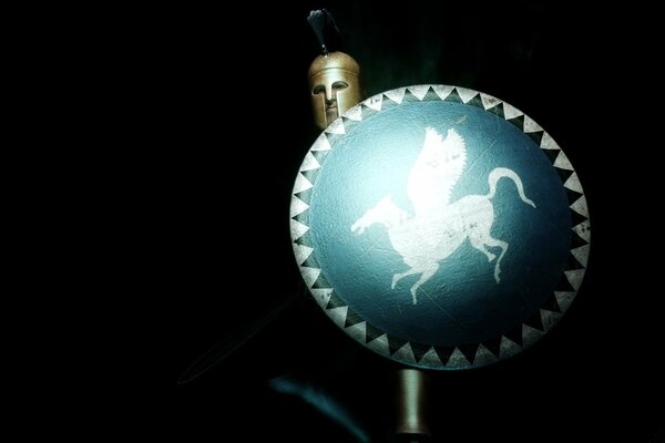 A warrior in armor with a shield on which Pegasus is depicted