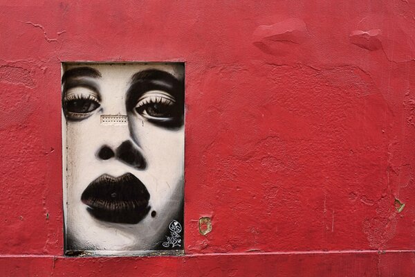 Pink wall with graffiti of a girl s face
