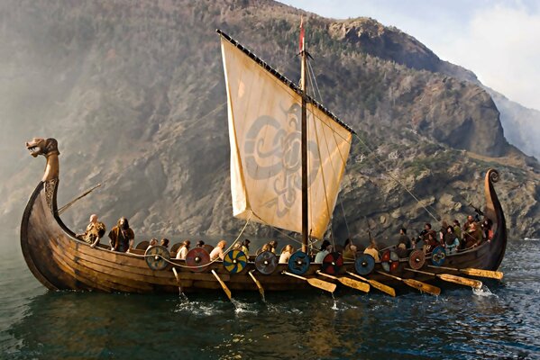 Vikings sail on a dragon ship in the sea