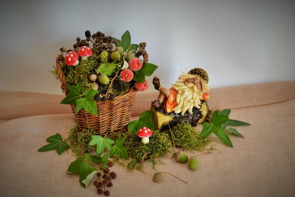 An unusual composition of a basket with a silhouette and fly agarics