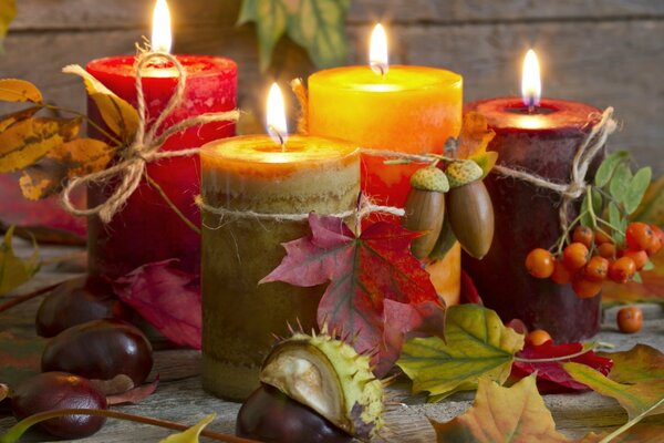 Still life in autumn style with candles and leaves