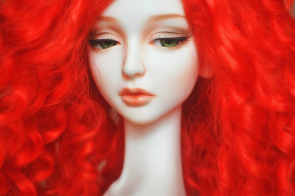 A doll with red hair and a sad look