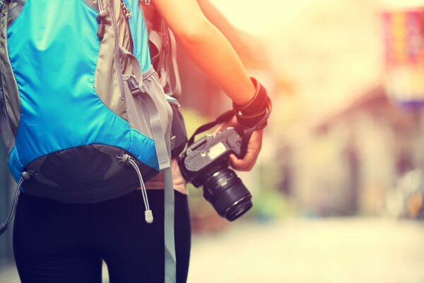 A girl with a backpack and a camera in her hand