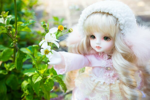 Toy blonde doll in a white dress