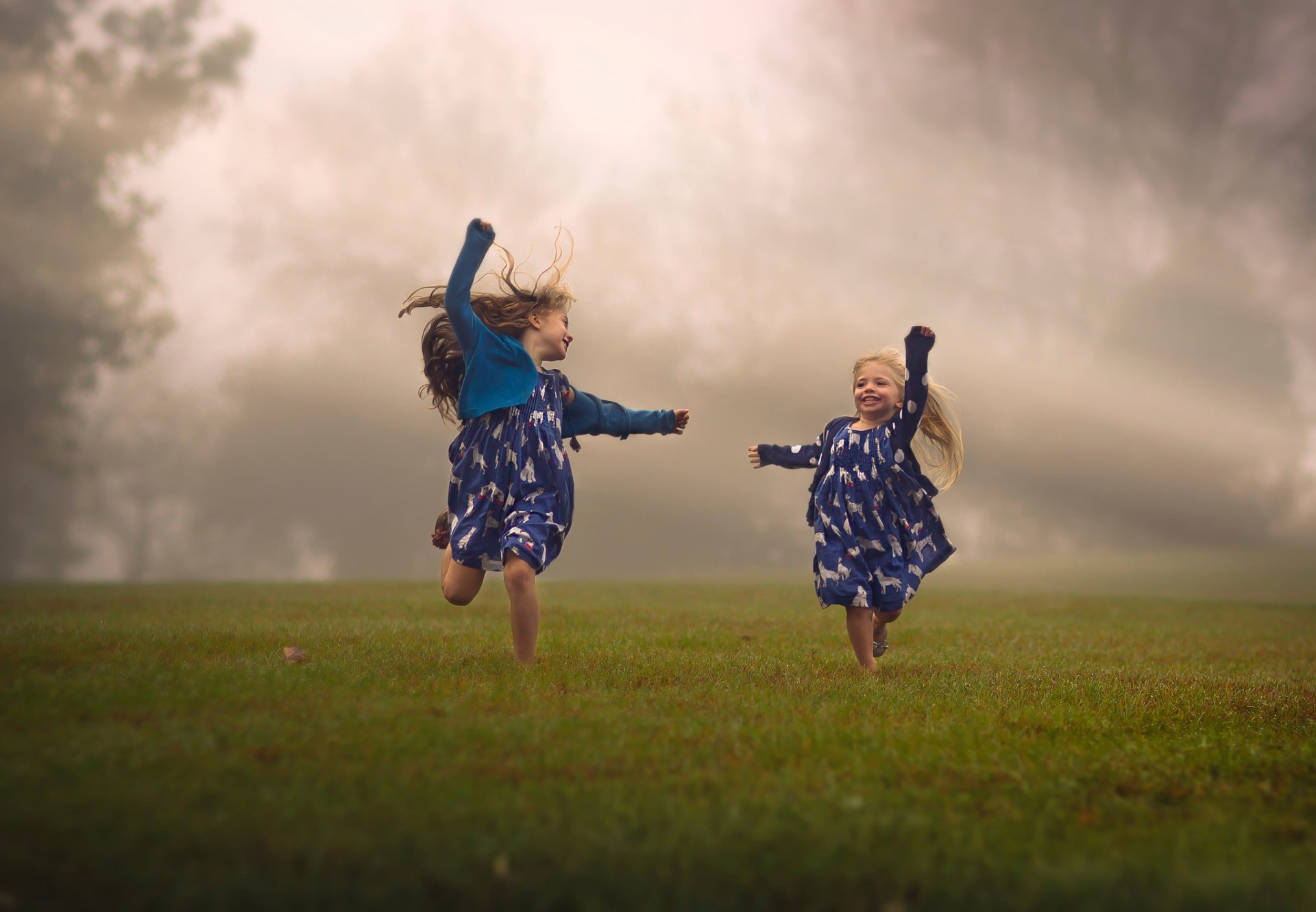 girls children running the field fog