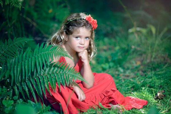 The look of a girl sitting and flowers in nature