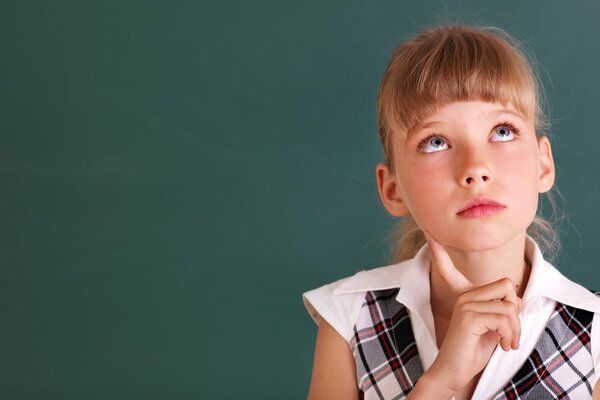 Thoughtful schoolgirl in a plaid shirt