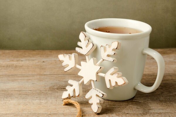 A cup of tea and a wooden snowflake