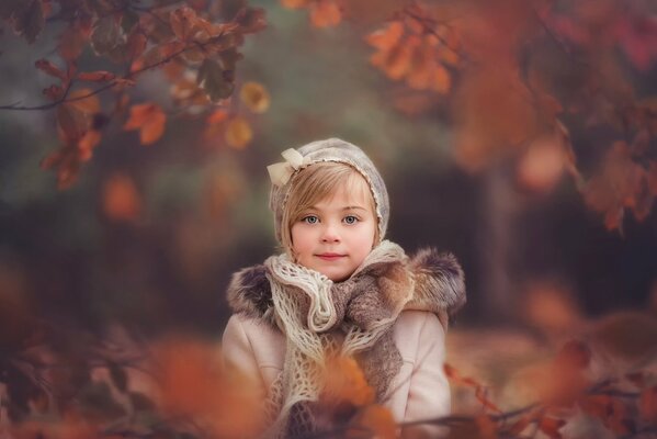 Autumn portrait of a girl in a hat and scarf in retro style