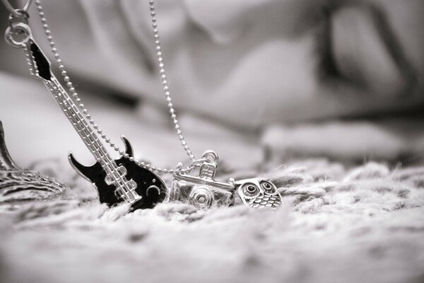 Jewelry in the form of a black and white guitar