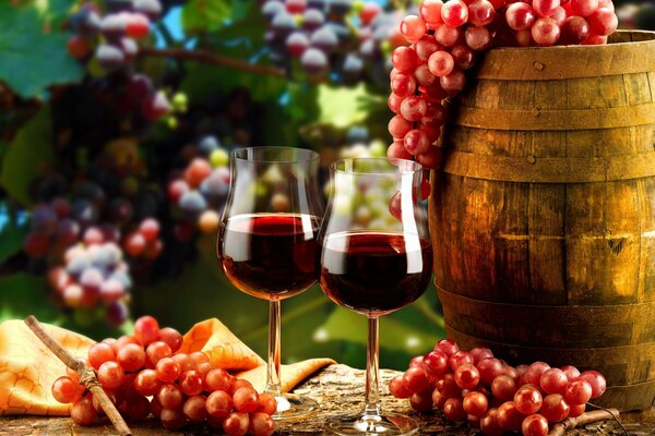 Two glasses of wine with grape branches and a wooden barrel