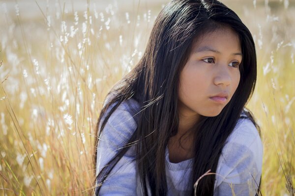 Beautiful dark-haired girl in the field