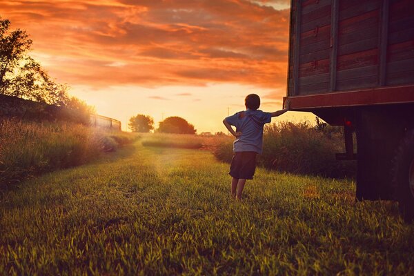 At sunset there is a tired boy