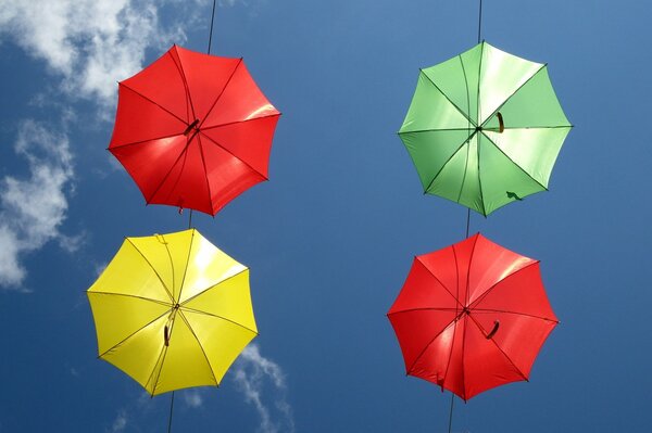 Beautiful bright umbrellas are depicted in the sky