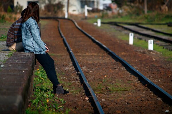 Fille debout à côté des rails