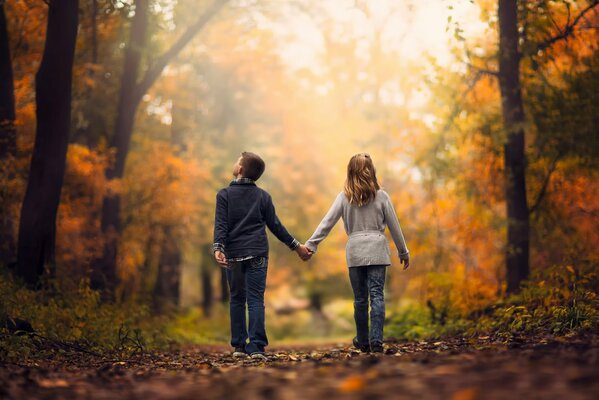 Children in love walk through the forest