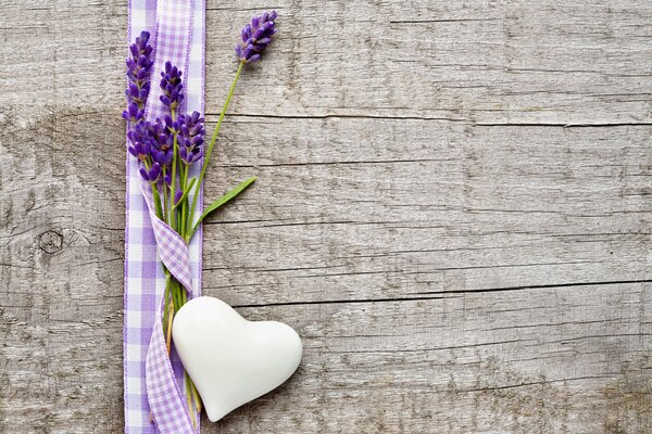 Lavender flowers in a ribbon on a wooden table