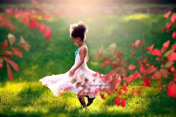 A girl in a dress in a green glade