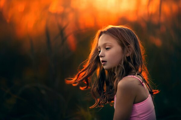 The girl s hair develops at sunset