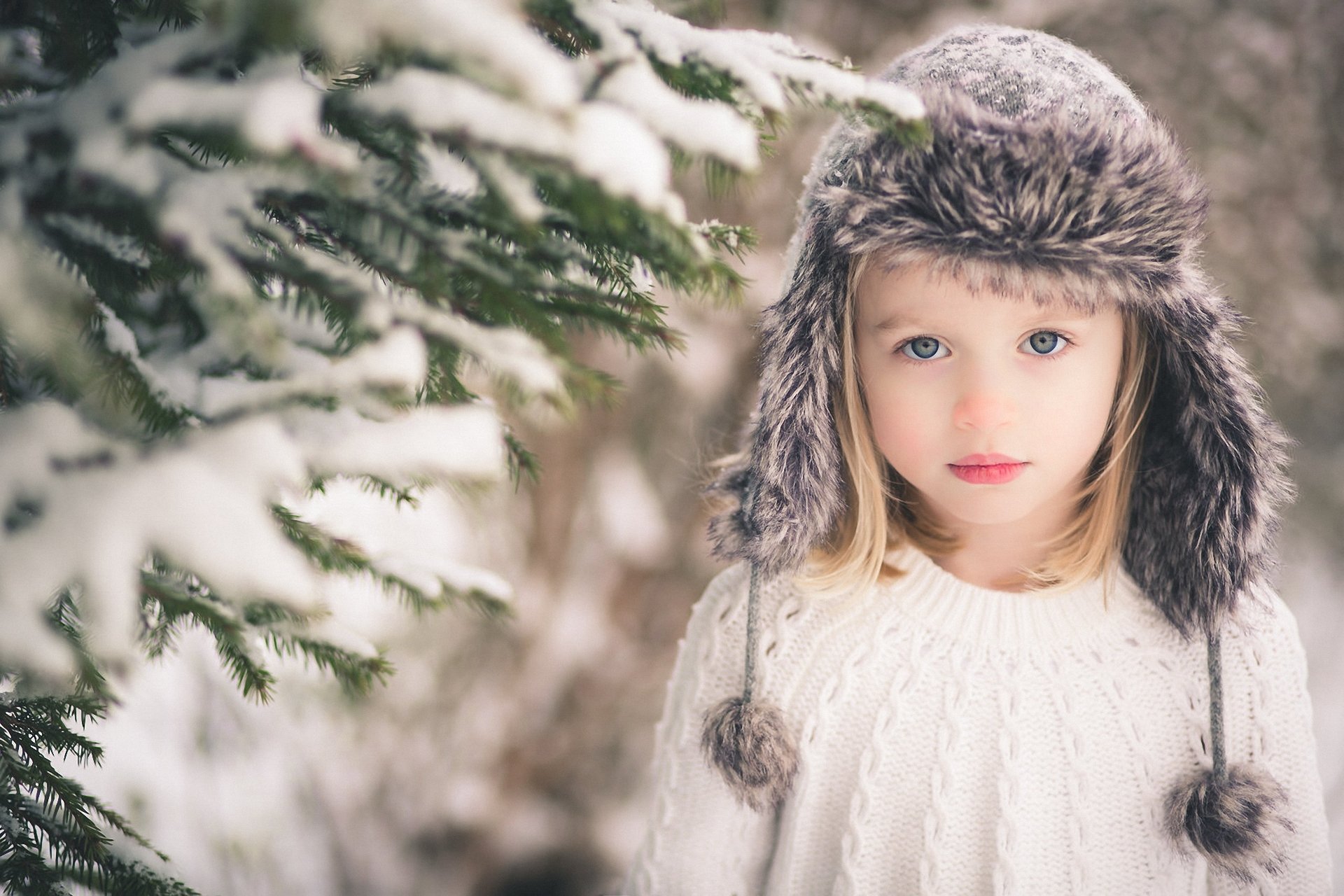 girl gray eyes blonde hat branches snow view