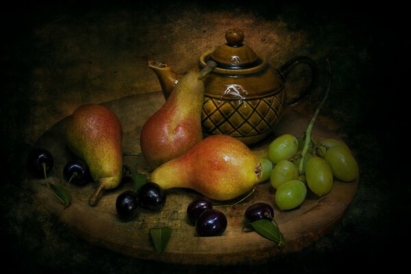 Still life on a tray of pears and grapes