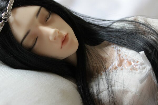 Realistic girl doll sleeping in pastel