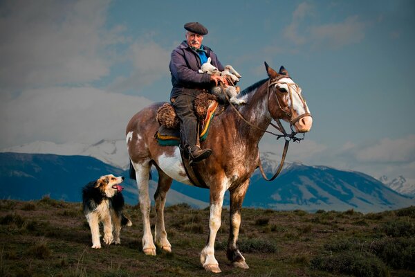 A shepherd on a horse with a lamb in his arms