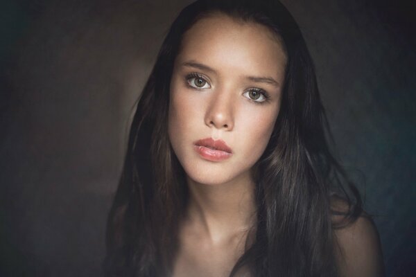 Portrait of a girl with long hair and straight eyes