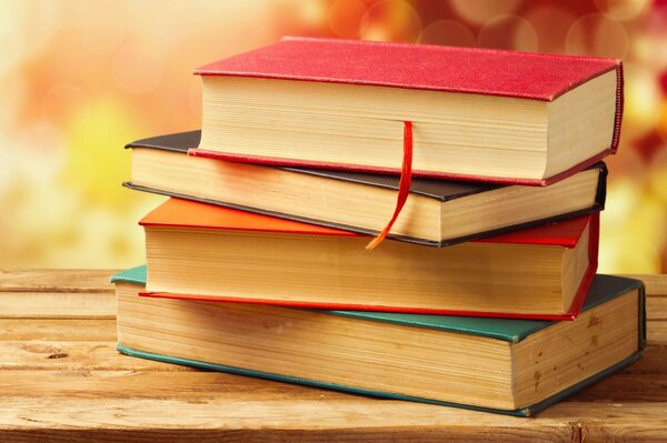 Books in colorful covers on a wooden table